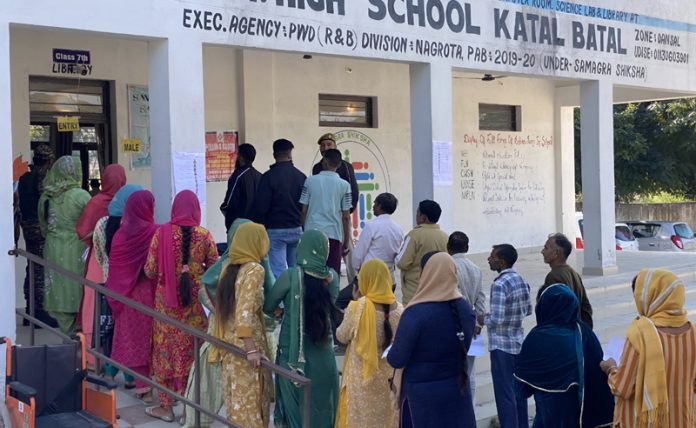 Voter casting ballot at Nagrota by-election polling booth
